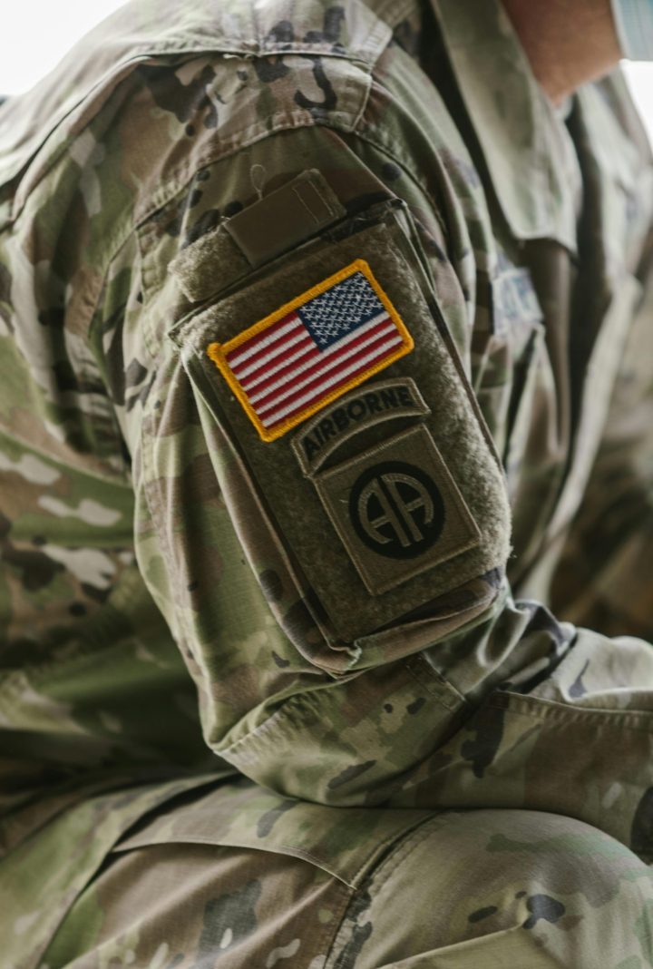 Detailed close-up of a military uniform sleeve featuring an American flag patch.
